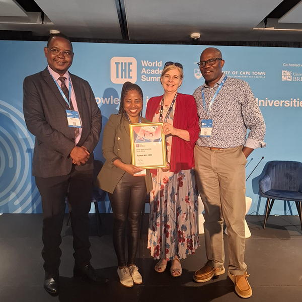 Prof. Mabutho Sibanda, executive dean of the Faculty of Economic and Management Sciences, Prof. Linda du Plessis, senior deputy vice-chancellor for Teaching and Learning, and Prof. Dumi Moyo, executive dean of the Faculty of Humanities, receive the certificate from a representative of Times Higher Education during the THE World Academic Summit.