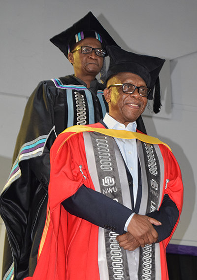NWU Deputy Registrar Prof Michael Temane caps veteran broadcaster Tim Modise during the conferral of an honorary doctorate in Communication Science at the Mahikeng Campus on 22 October 2026, in recognition of his contribution to South African broadcasting, journalism and democratic dialogue.